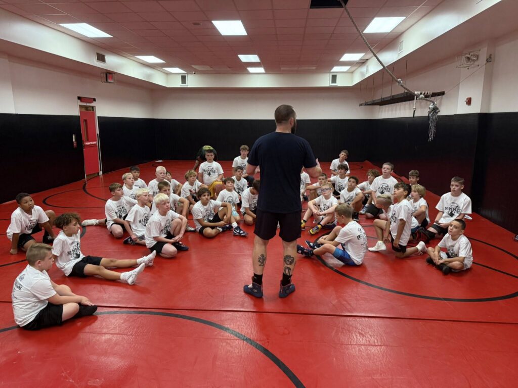 SCH Wrestling Club Students listening to Coach Josh Dziewa discuss Wrestling Techniques
